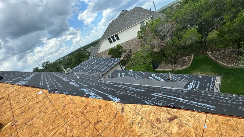 Synthetic underlayment over fresh decking during a Central Texas roof replacement