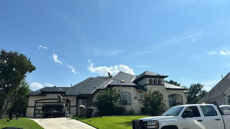 HWT Construction crew replacing the roof on a Central Texas stone home