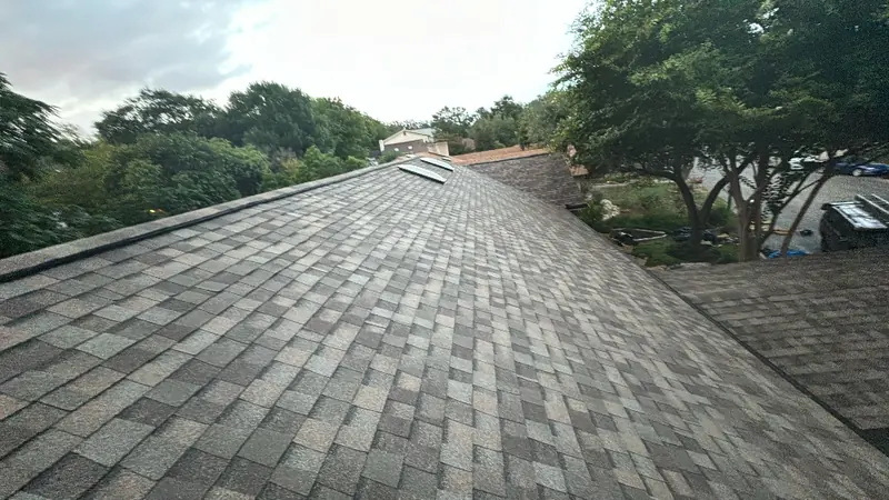 Completed ridge line and new shingles on a Central Texas roof