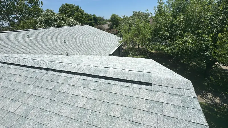 Finished shingle plane and chimney on a Central Texas roof