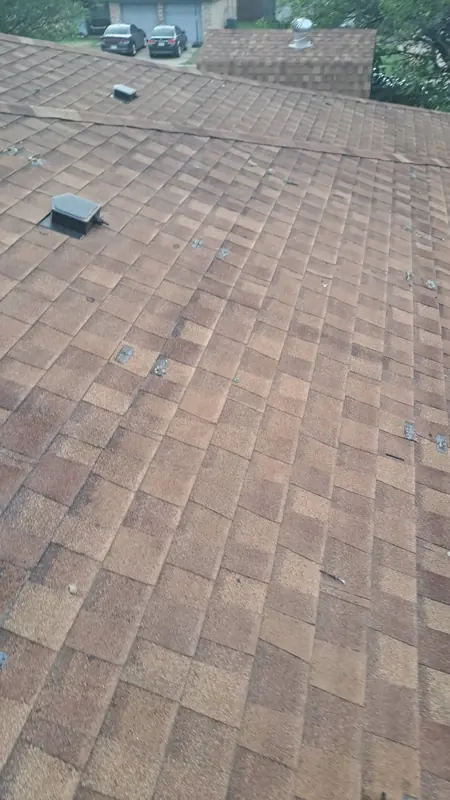 Storm-damaged asphalt shingle roof in Central Texas marked up during inspection