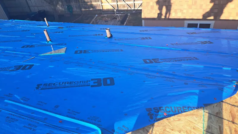 Synthetic underlayment installed over decking on a Central Texas roof