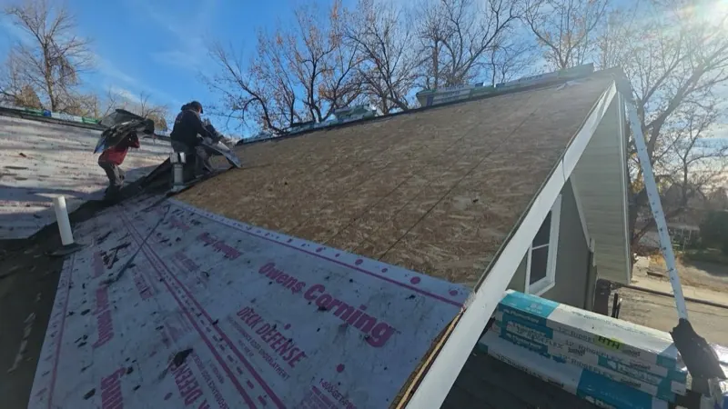 HWT Construction crew tearing off old shingles in Havre, MT