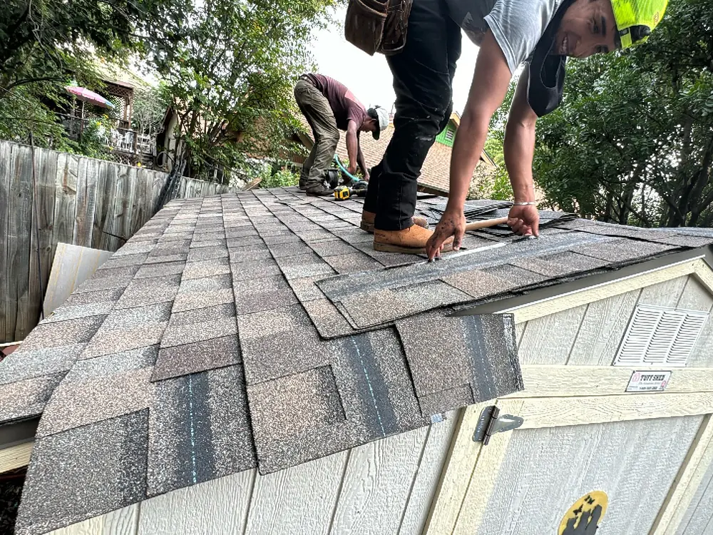 HWT Construction crew installing new architectural shingles in Central Texas