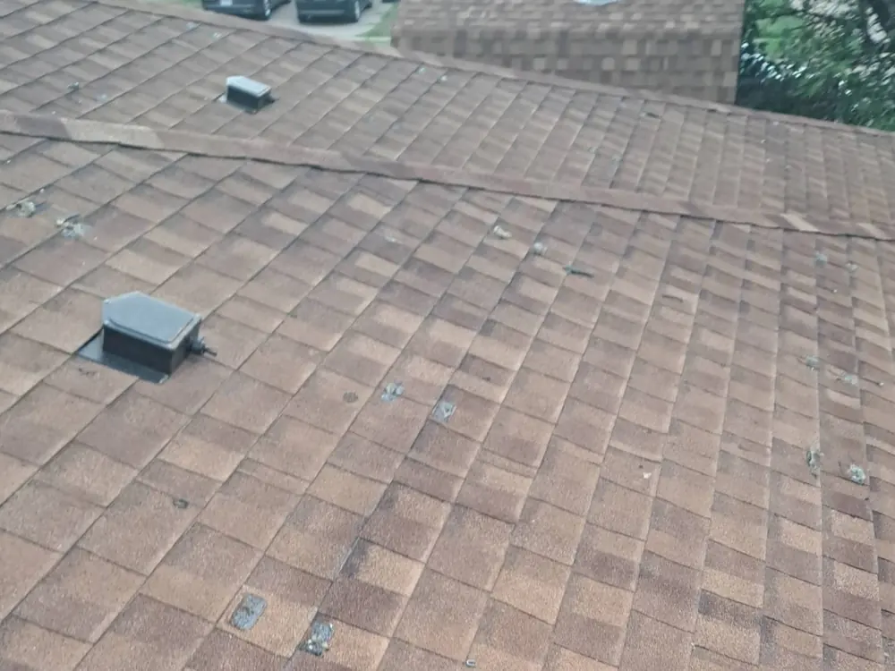 Storm-damaged asphalt shingle roof in Central Texas marked up during inspection